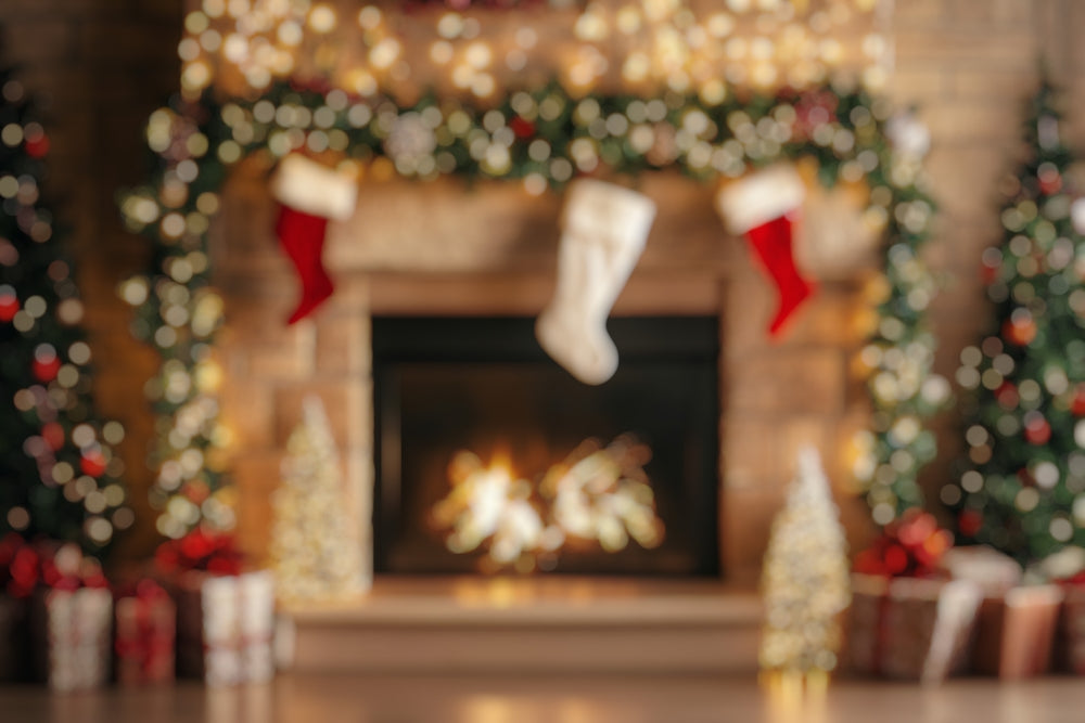 Blurred image of a cozy fireplace adorned with a lit garland, red and white stockings, wrapped packages with bows, and a softly lit Christmas tree on each side, symbolizing warmth and holiday healing.